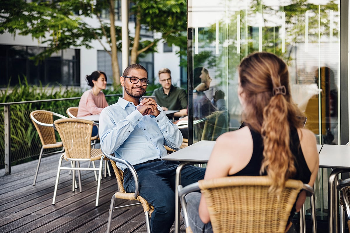 Man with glasses sitting outside